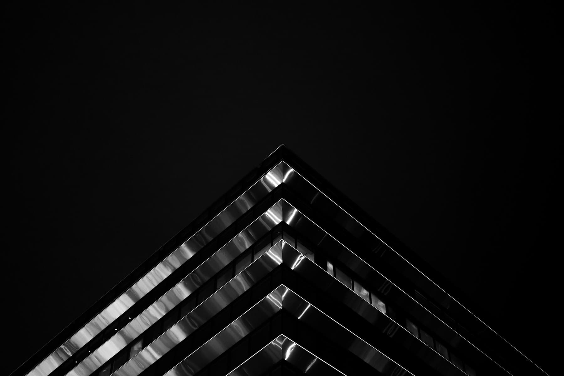 Stacked balconies of a tower converging into darkness